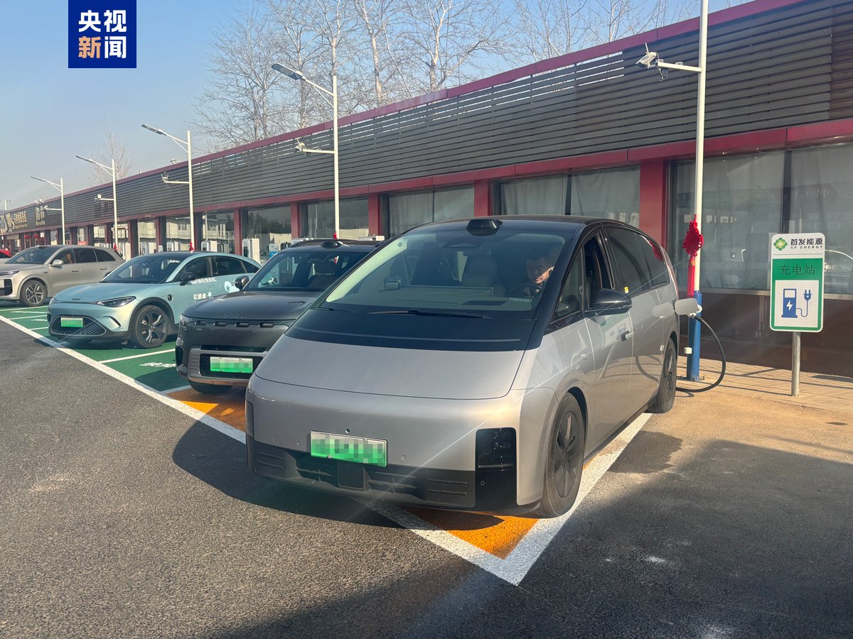 Electric vehicles charging at a Beijing highway service area in 2026