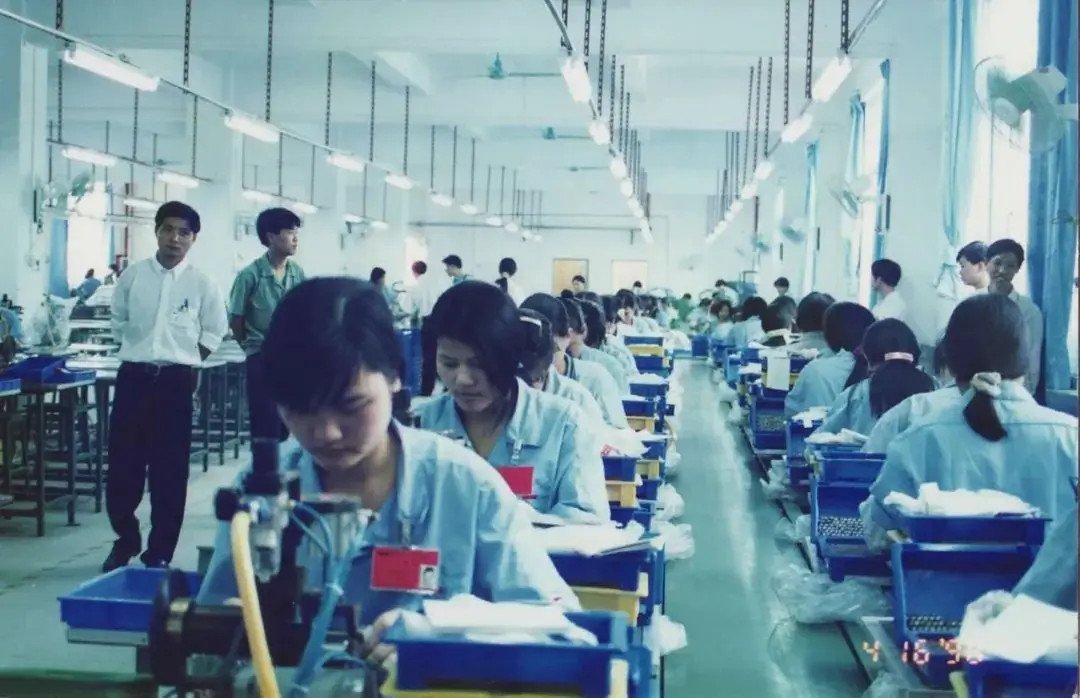 Workers on an early BYD manual battery production line