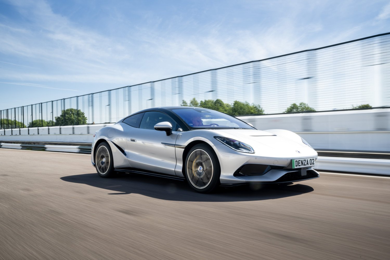 Silver Denza Z Coupe driving on a road