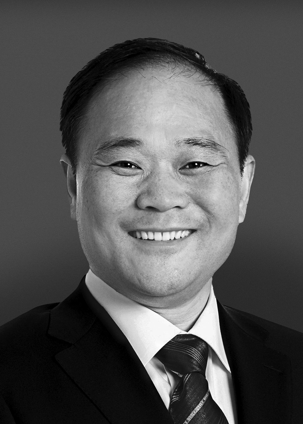 Official black-and-white portrait of Geely founder Li Shufu