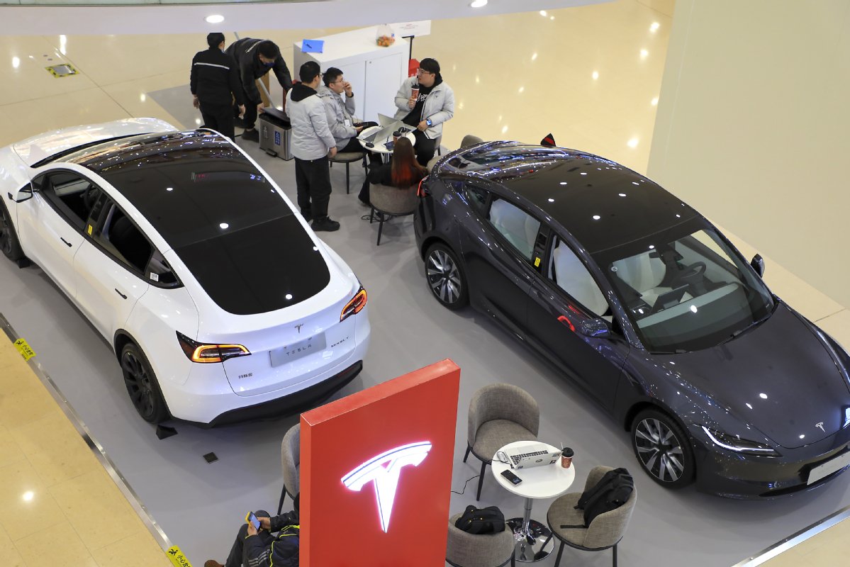Tesla Model 3 and Model Y vehicles displayed in a Shanghai showroom