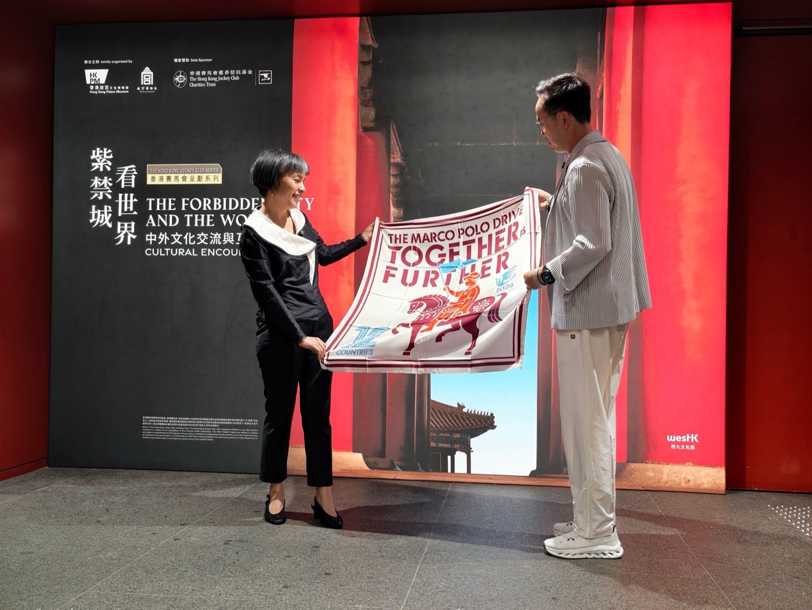 Marco Polo Drive participants displaying the journey flag at the Hong Kong final stop